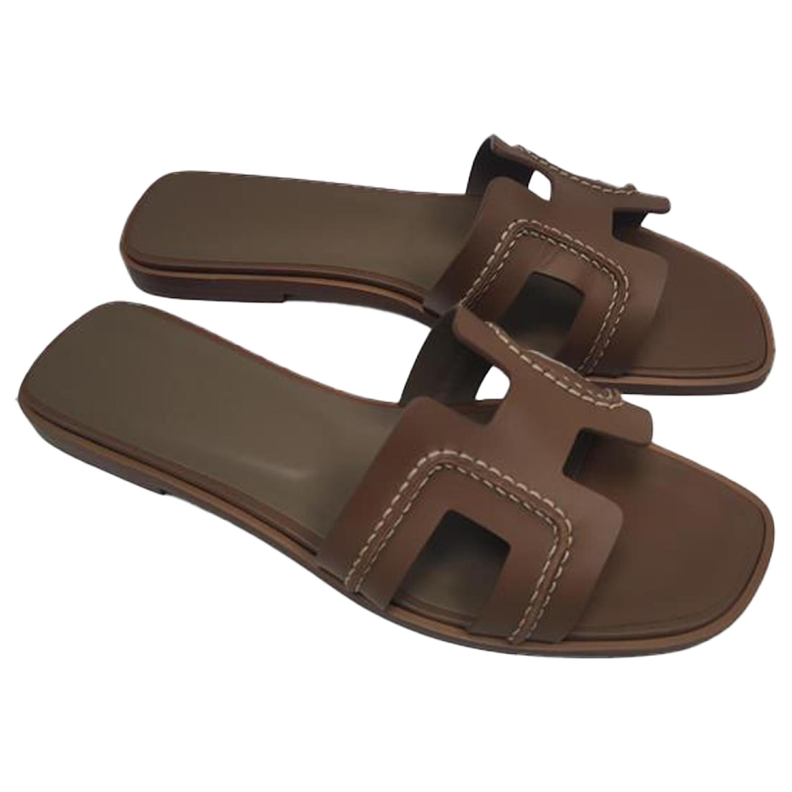 Hermès Oran Flat Slides in Brown Leather Pony-style calfskin  ref.2196039
