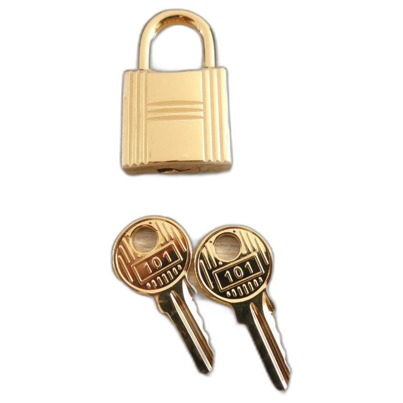 Hermès lock for Hermès Kelly and Birkin bags, gold-plated steel with 2 keys Gold hardware  ref.2277429